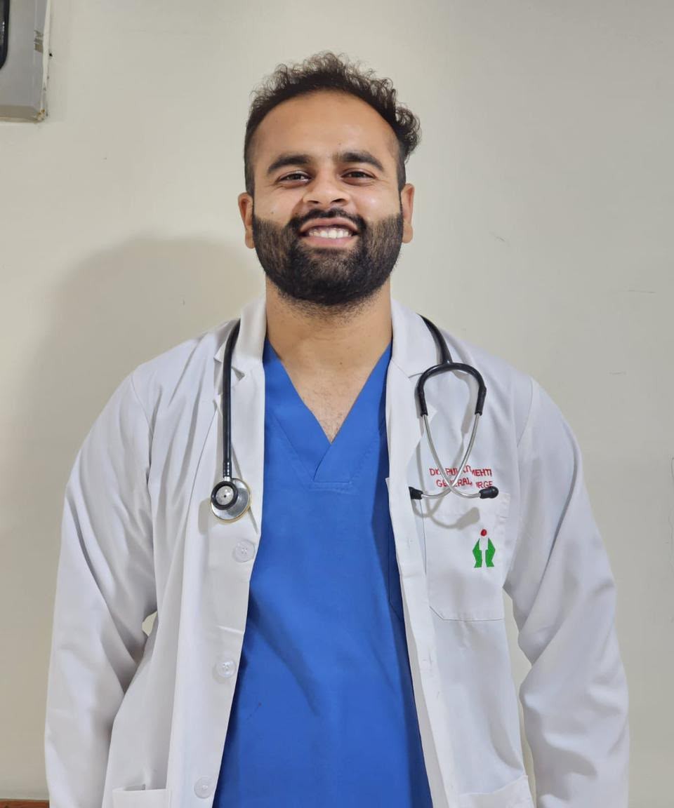 Dr. Pulkit Mehta, MBBS, in a white coat with a stethoscope at Mehta Hospital, Radaur, Haryana